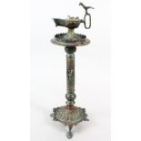 A 13TH CENTURY ISLAMIC BRONZE LAMP, the top with an Aladdin type lamp, 45cm high.