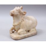 A 19TH CENTURY OR EARLIER INDIAN CARVED MARBLE FIGURE OF A NANDI BULL, the bull carved in