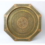 A RARE 19TH CENTURY ISLAMIC NASRID REVIVAL BRASS OCTAGONAL SHAPED TRAY, the centre inlaid with