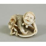 A JAPANESE MEIJI PERIOD CARVED IVORY NETSUKE OF A MAN, the man leant over his pan working, with a