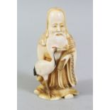 A GOOD JAPANESE MEIJI PERIOD CARVED IVORY NETSUKE OF A LUCKY GOD, holding a scroll in his left hand,