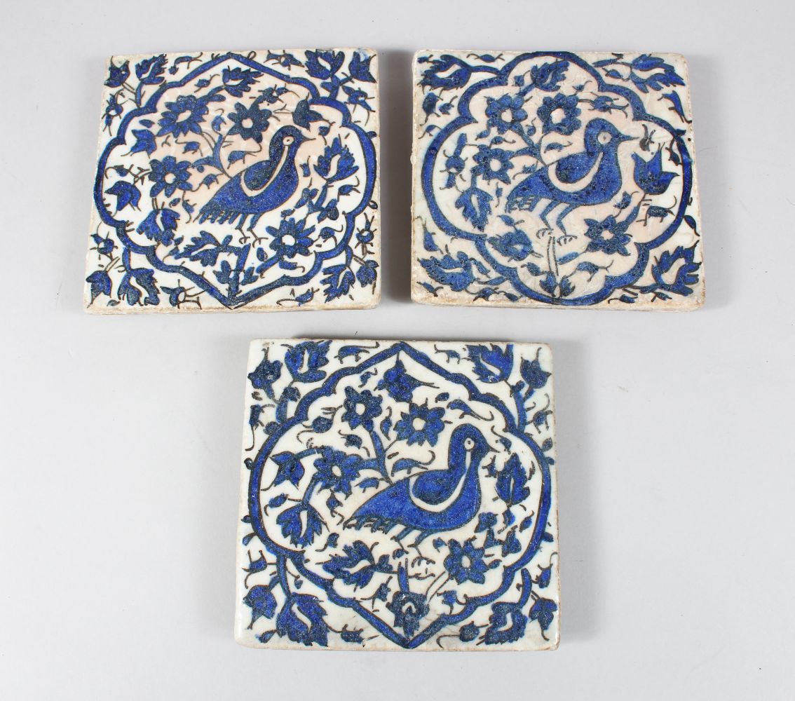 THREE 18TH/19TH CENTURY PERSIAN TILES, each decorated with birds amongst foliage, 15.5cm x 15.5cm