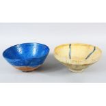 TWO KASHAN CIRCULAR POTTERY BOWLS, one with blue streaks 19cm diameter, and another blue glazed 19cm