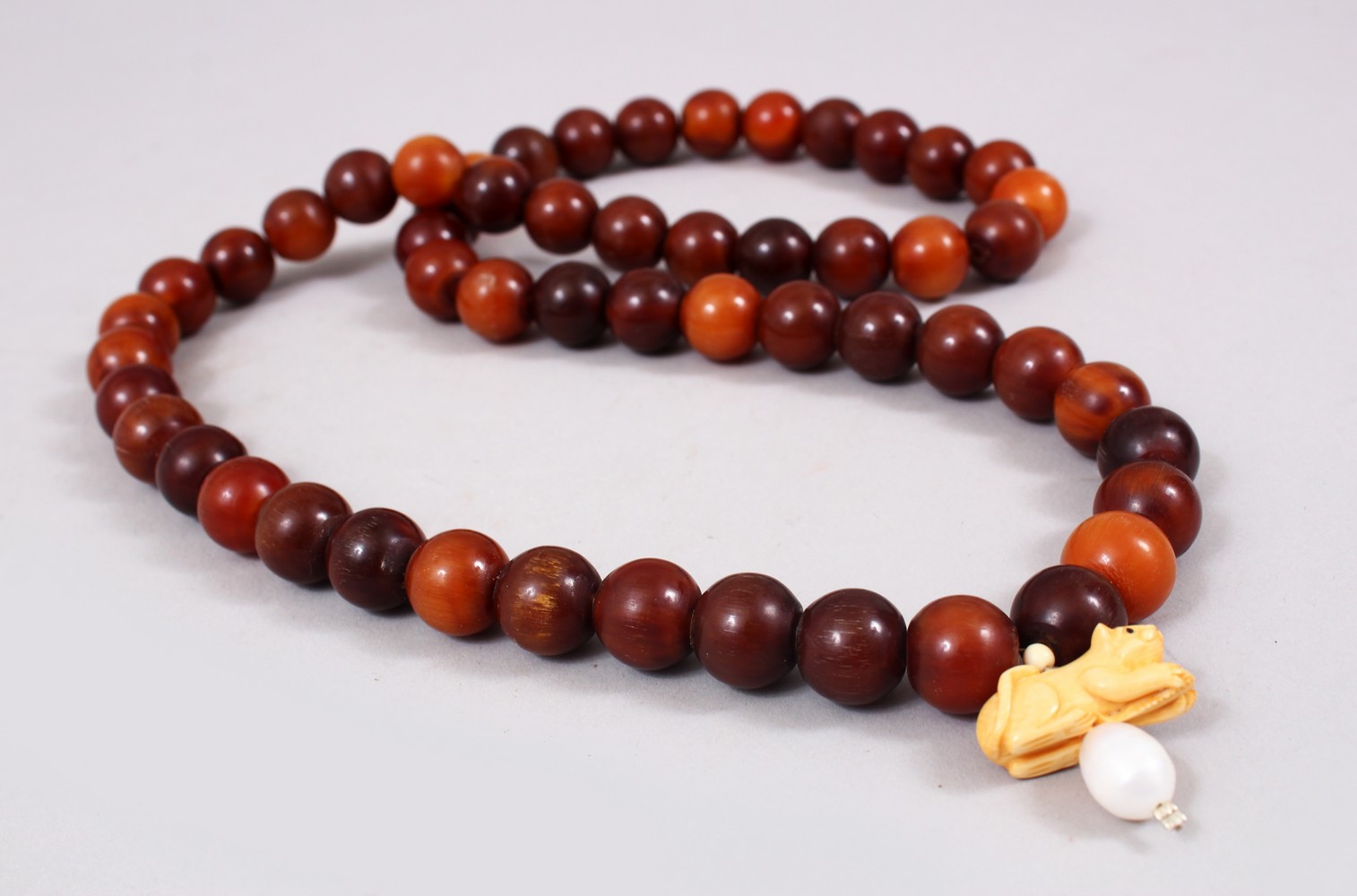 A CHINESE HORN BEAD NECKLACE / ROSARY BEADS , comprising of 54 spherical beads approx 1.1cm, with