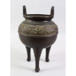 A 20TH CENTURY CHINESE BRONZE TWIN HANDLE CENSER, with a band of decoration on three legs, 30cm
