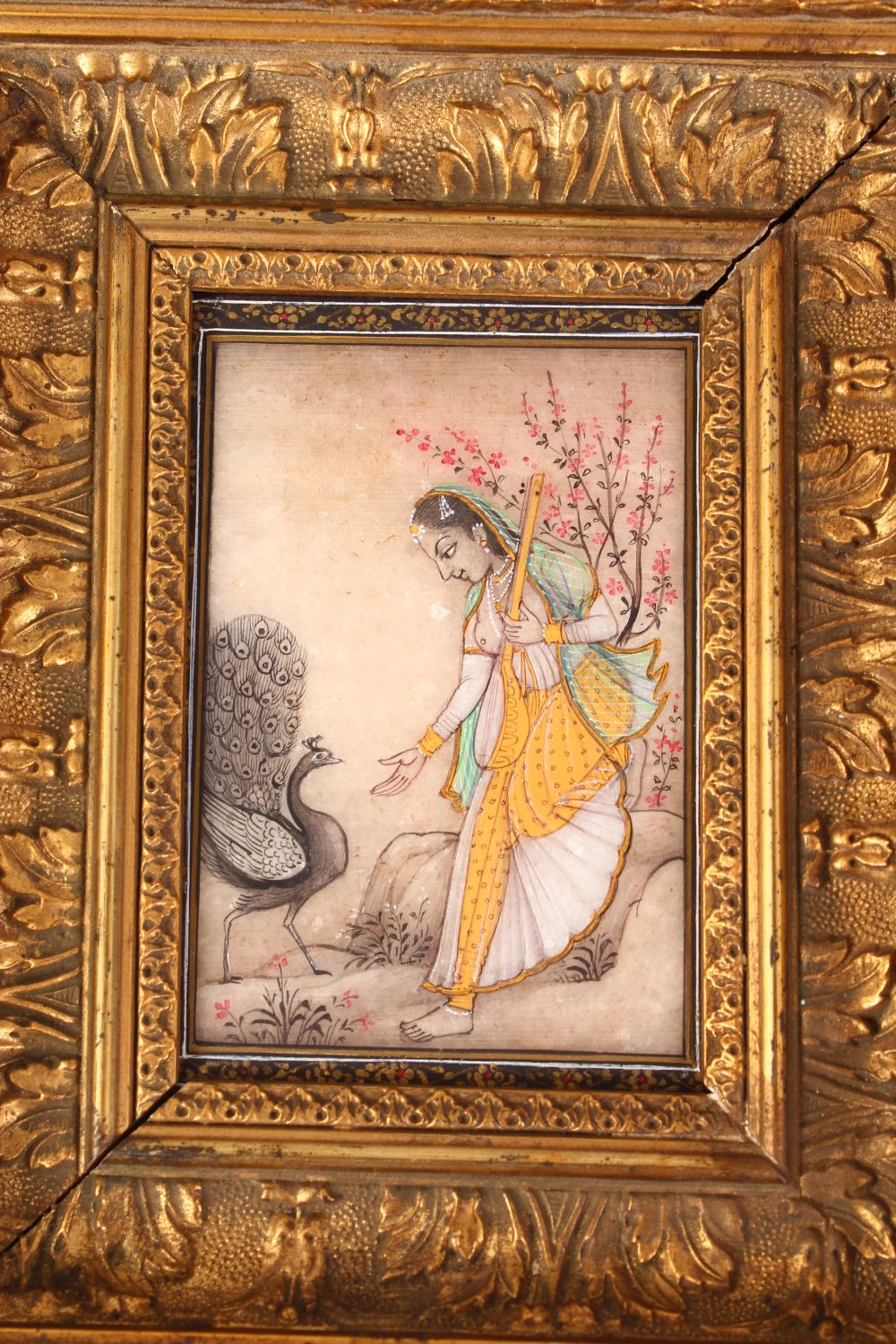 INDIAN SCHOOL, A FEMALE FIGURE HOLDING A MAGICAL INSTRUMENT, A PEACOCK BY HER SIDE, painted on a - Image 2 of 6