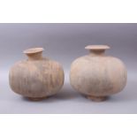 A PAIR OF UNUSUAL EARLY CHINESE BARREL SHAPED TERRACOTTA BURIAL URNS, with broad circular shaped