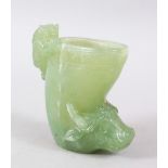 A GOOD CHINESE CARVED JADE / JADE LIKE LIBATION TYPE CUP, with a kylin and water buffalo, 10cm