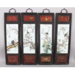 A SET OF FOUR CHINESE CARVED WOOD & PORCELAIN HANGING WALL PANELS, each panel depicting scenes of