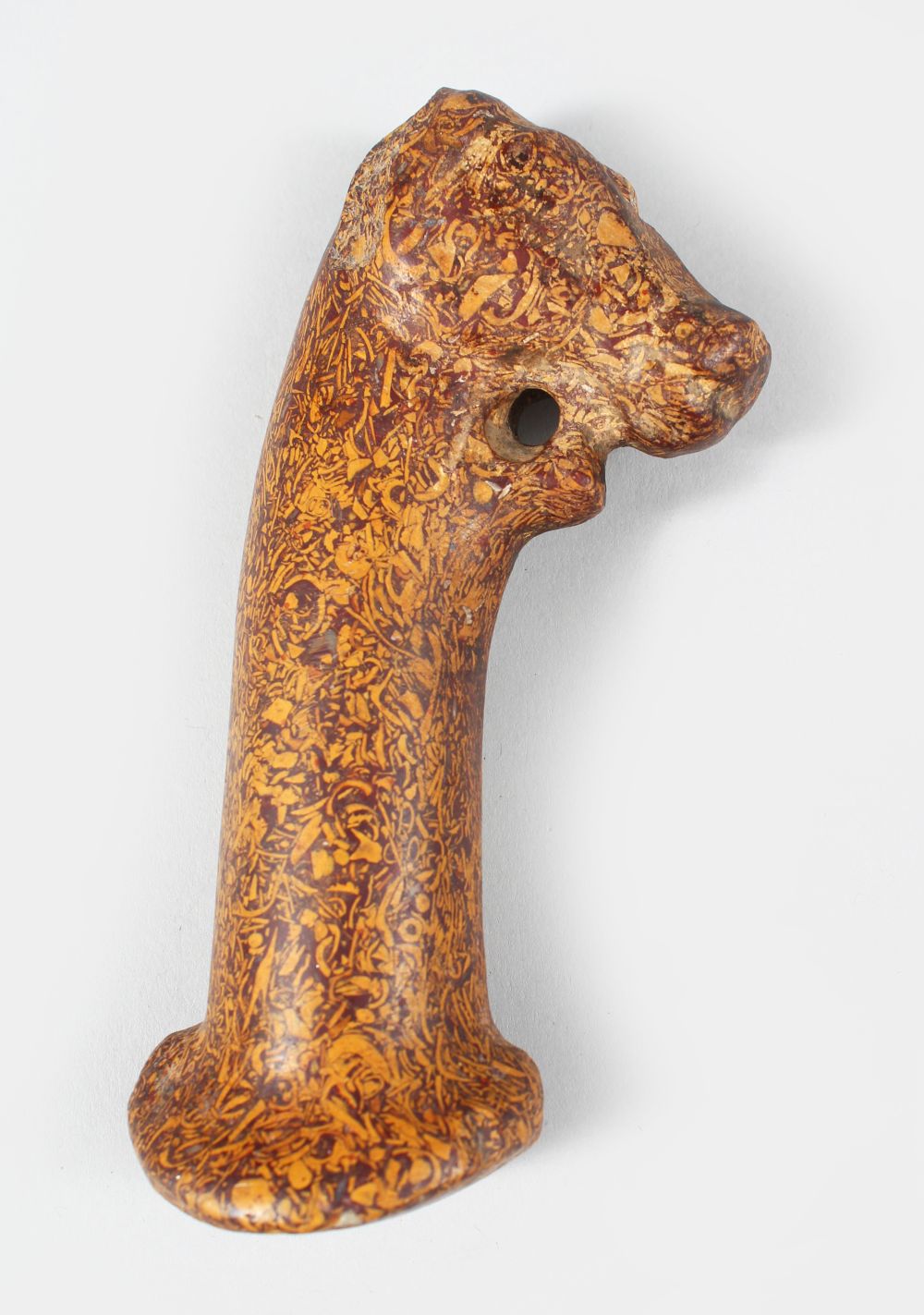 AN EARLY INDIAN CARVED STONE DAGGERS HANDLE IN THE FORM OF A HORSES HEAD, 14cm long.