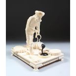 A 19TH CENTURY CARVED INDIAN IVORY MODEL OF A SNAKE CHARMER, the man stood over two snakes with a