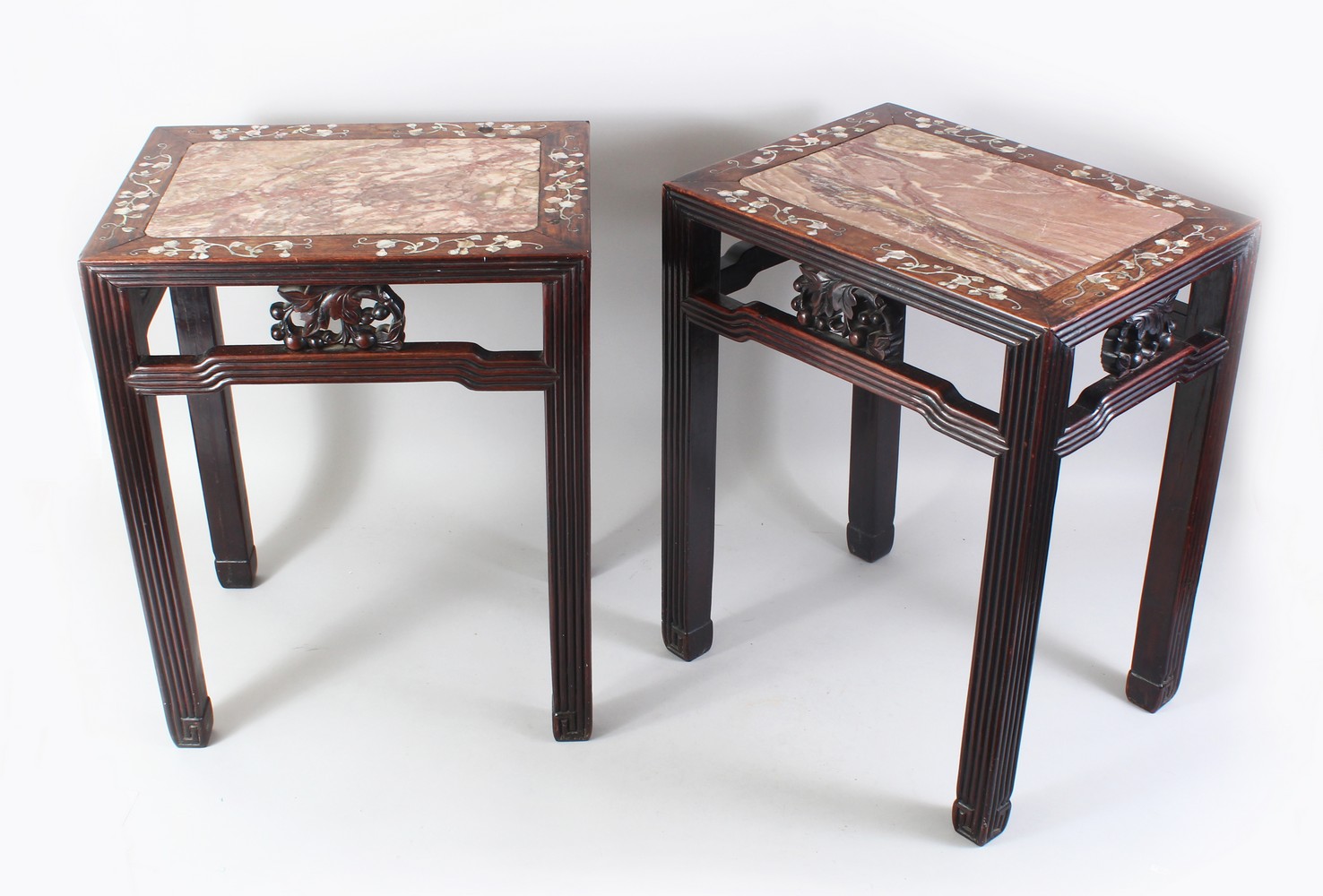 A GOOD PAIR OF 19TH CENTURY CHINESE HARDWOOD AND MOTHER OF PEARL MARBLE TOP STANDS, the tops inset