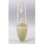 A GOOD CHINESE CARVED CELADON JADE VASE, the vase with a carved and fitted lid, the twin c arved