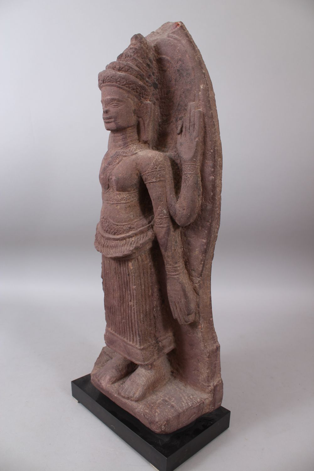 A 12TH CENTURY STYLE CAMBODIAN KHMER STYLE RED SANDSTONE CARVING OF A FOUR ARMED DEITY. 52cms high. - Image 4 of 6