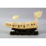 A GOOD 19TH / 20TH CENTURY CHINESE CARVED IVORY MODEL OF A SHIP, the ship carved with figures,