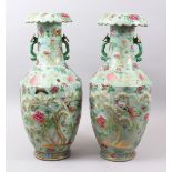 A LARGE PAIR OF 19TH CENTURY CHINESE CELADON CANTON FAMILLE ROSE PORCELAIN VASES, the body of each