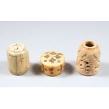 THREE EARLY ISLAMIC CARVED IVORY GAMING PIECES, 3.5CM, 3.7CM &1.5CM HIGH.