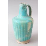 AN EARLY KASHAN TURQUOISE GLAZED POTTERY JUG, 21cm high.