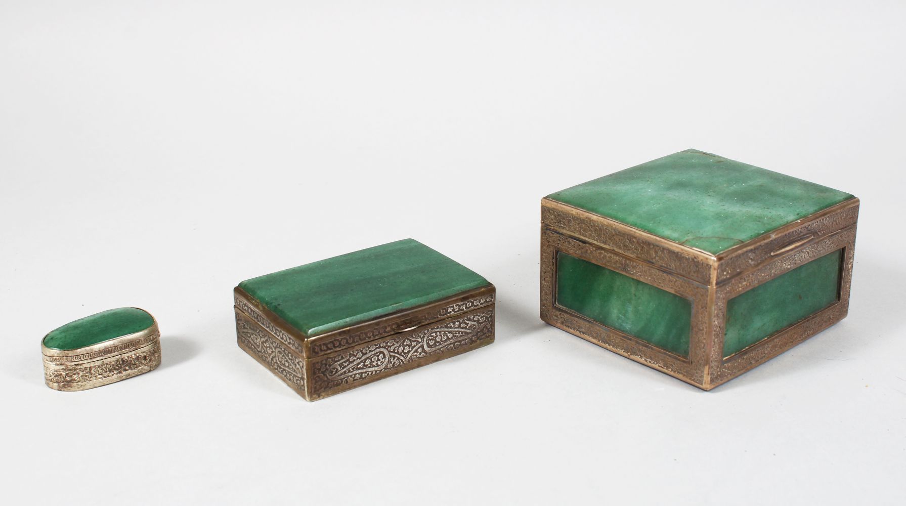 A COLLECTION OF THREE INDIAN CASHMIRI SILVER MOUNTED GREEN HARDSTONE BOXES, largest 10cm wide