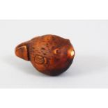 A JAPANESE MEIJI PERIOD CARVED WOODEN NETSUKE OF A FUGU FISH, the puffer fish with ivory inlaid