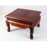 A SMALL 20TH CENTURY CHINESE HARDWOOD STAND, with a rectangular top on four curving legs, 41cm x