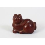 A JAPANESE LATE EDO PERIOD CARVED BOXWOOD NETUSKE OF A DOG, the dog in a resting position, with