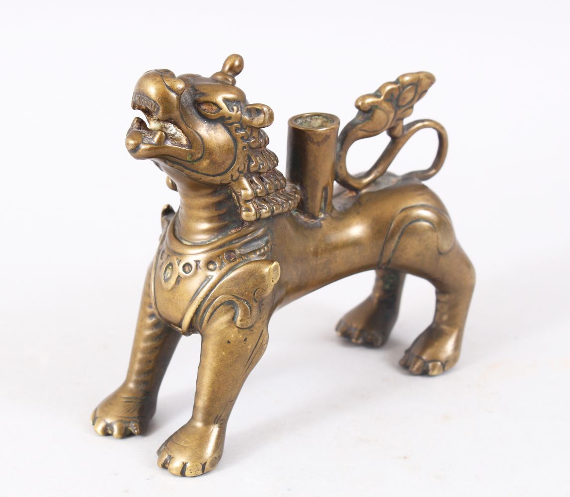 A FINE 15TH - 17TH CENTURY TIBETAN BRONZE FIGURE OF A LION / INCENSE, stood in a striking pose, 11cm