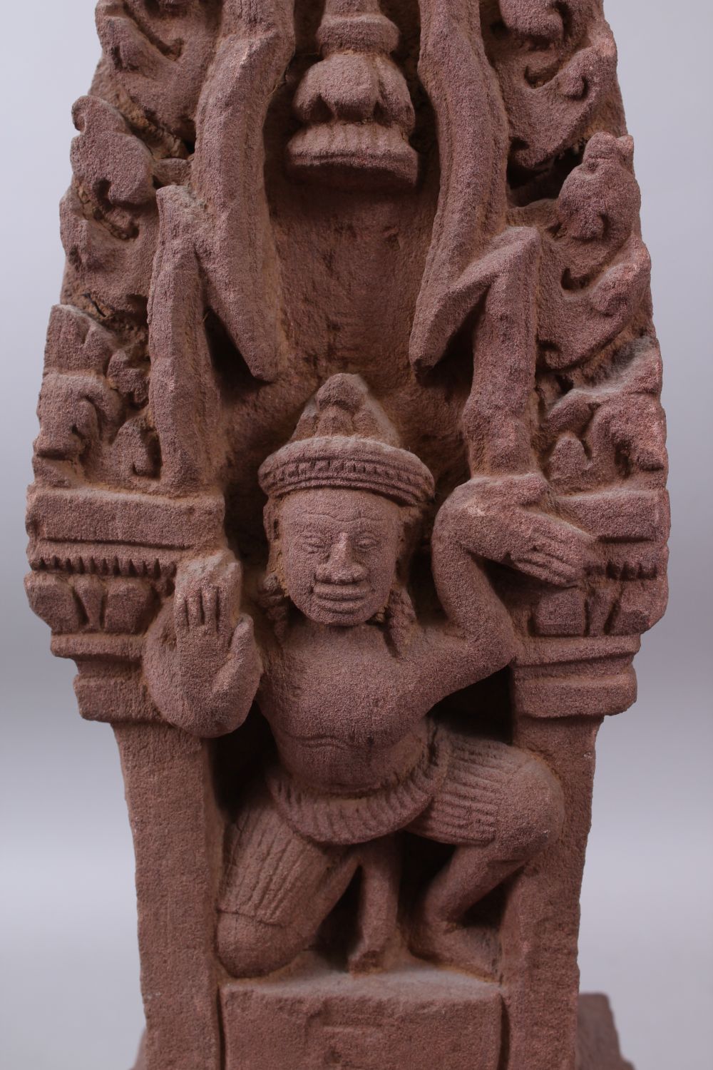 A CAMBODIAN KHMER STYLE CARVING OF A CROUCHING FIGURE IN A TEMPLE. - Image 2 of 6