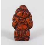 A JAPANESE EDO PERIOD CARVED WOODEN NETSUKE OF HOTEI, one of the seven lucky gods of Japan, stood