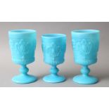 A SET OF THREE TURQUOISE OPALINE GLASS WINE CUPS, 13.5cm and 15cm high (3).