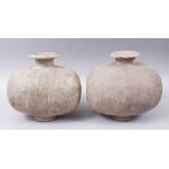 A PAIR OF UNUSUAL EARLY CHINESE BARREL SHAPED TERRACOTTA BURIAL URNS, with broad circular shaped