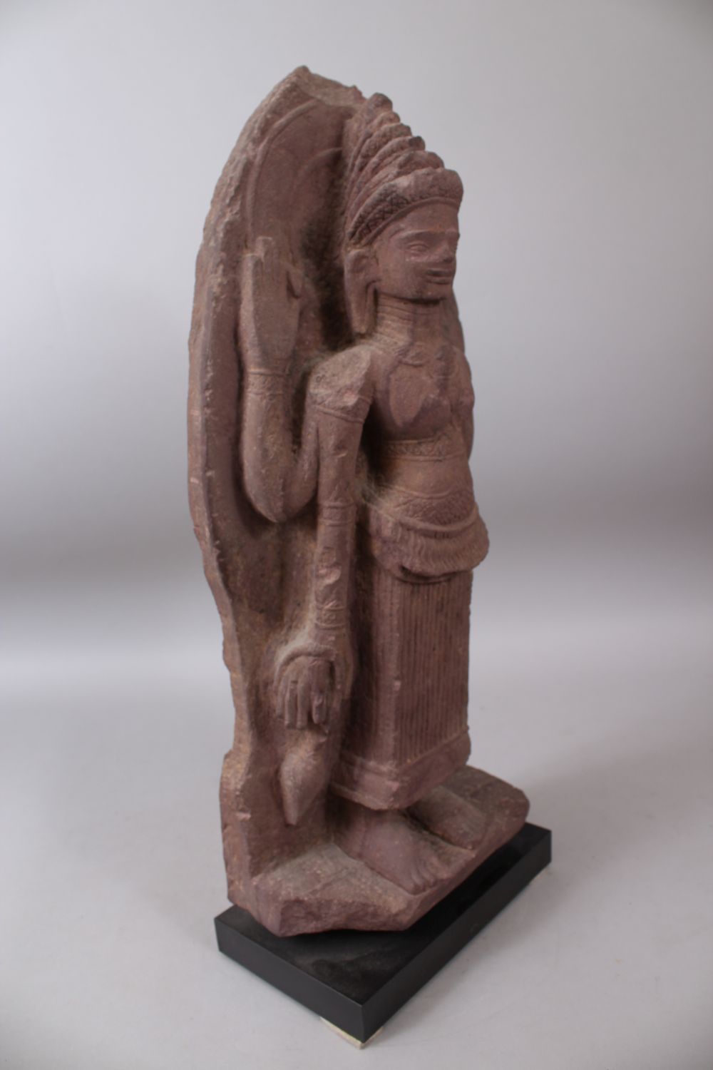 A 12TH CENTURY STYLE CAMBODIAN KHMER STYLE RED SANDSTONE CARVING OF A FOUR ARMED DEITY. 52cms high. - Image 2 of 6