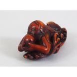 A JAPANESE EDO / MEIJI PERIOD CARVED WOODEN NETSUKE OF NINGYO, the mermaid in a led position upon