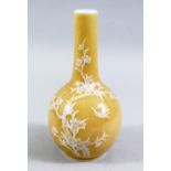 A 19TH / 20TH CENTURY CHINESE YELLOW GROUND PORCELAIN BOTTLE VASE, with white glazed decoration,