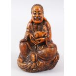 A GOOD CHINESE CARVED SOAPSTONE FIGURE OF LUOHAN HOLDING A CHILONG, seated on a stylized cloud base,