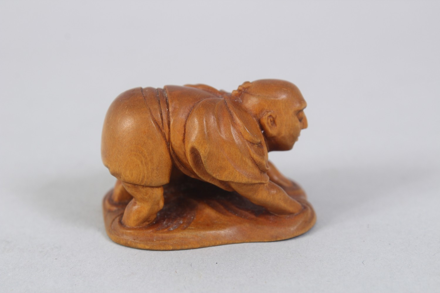 A JAPANESE MEIJI PERIOD CARVED BOXWOOD NETSUKE OF A CLAM FISHERMAN, stood knee deep in water feeling - Image 2 of 4