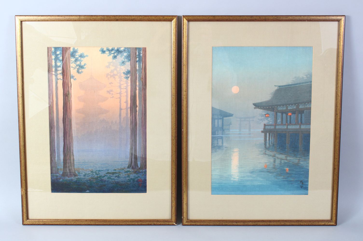 A GOOD PAIR OF JAPANESE SCHOOL WATERCOLOUR PAINTING, a temple at sunset and houses on a river at