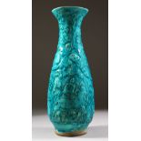 A PERSIAN QAJAR TURQUOISE GLAZED VASE, with moulded deer and hares in foliage, 34cm high.