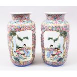 A GOOD PAIR OF 19TH / 20TH CENTURY CHINESE FAMILLE ROSE PORCELAIN VASES, each vase decorate with