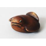 A JAPANESE 20TH CENTURY CARVED WOODEN NETSUKE OF A FUKURA SUZUME, the bird in seated position, the