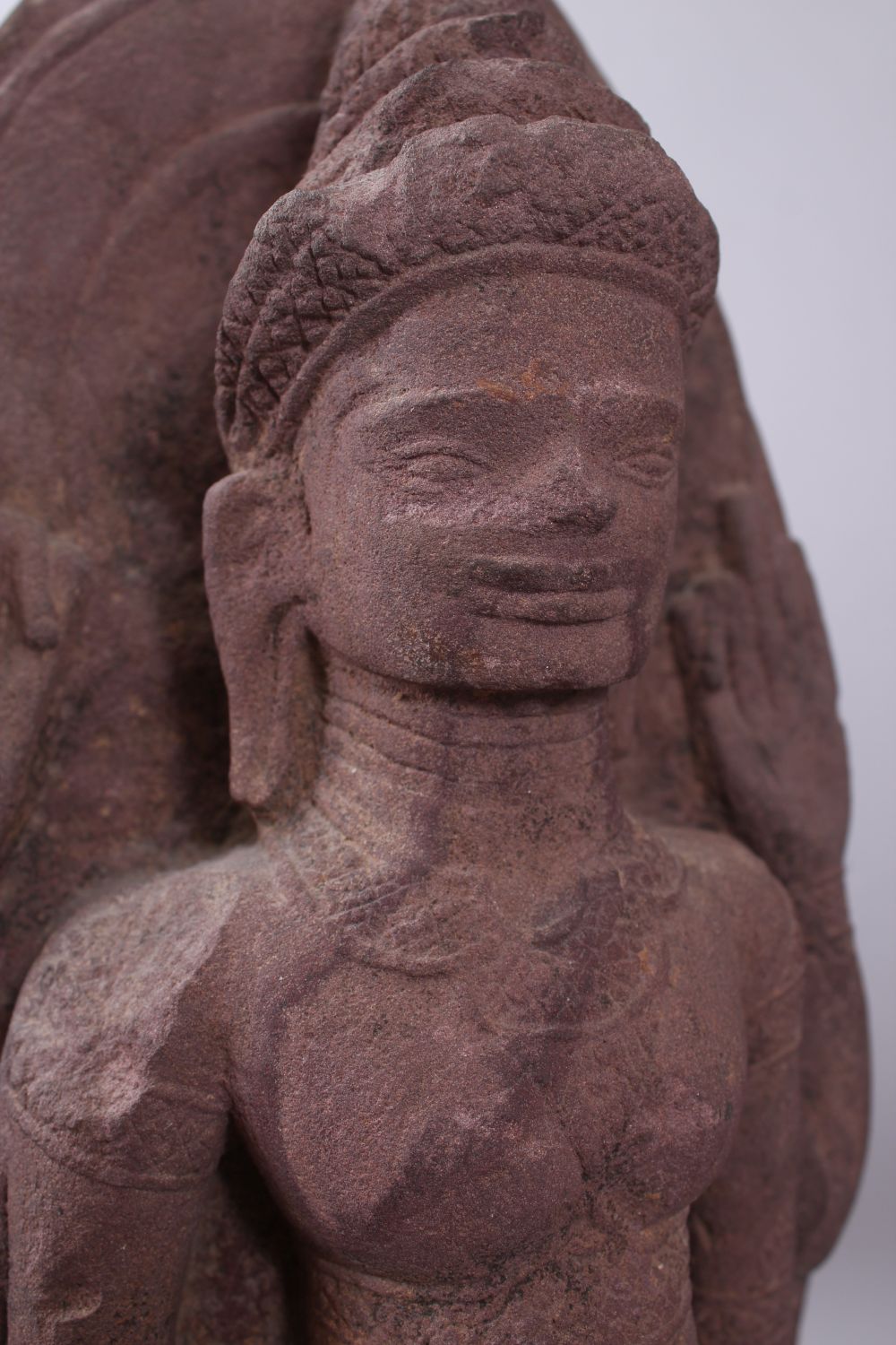 A 12TH CENTURY STYLE CAMBODIAN KHMER STYLE RED SANDSTONE CARVING OF A FOUR ARMED DEITY. 52cms high. - Image 3 of 6