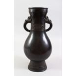 A GOOD 18TH / 19TH CENTURY CHINESE BRONZE TWIN HANDLED VASE, of fluttered ovoid form, dragon head