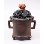 A GOOD CHINESE TWIN HANDLE BRONZE LIDDED CENSER, the censer with twin handles and sat upon three