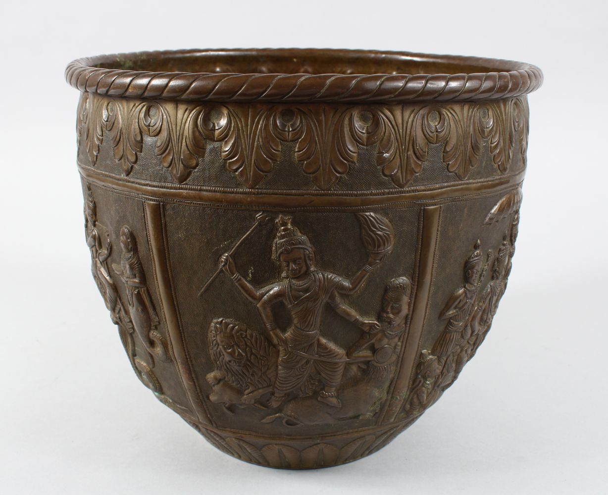 A GOOD AND LARGE INDIAN BRASS JARDINIERE, the body with panel decoration depicting figures and