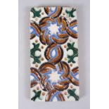 A GOOD 17TH CENTURY HISPANO MORESQUE TILE, with decoration using biscuit, blues and green, 27.5cm