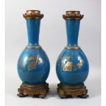 A PAIR OF 19TH CENTURY CHINESE PORCELAIN BOTTLE VASES / LAMP BASES, the ground with gilded