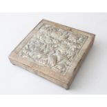LATE 19TH CENTURY PERSIAN WHITE METAL BOX, the hinged cover embossed with birds and foliage within