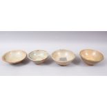 FOUR EARLY CHINESE POTTERY GLAZED BOWLS, some glazed, some partially glazed, various sized but