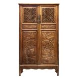 A LARGE CHINESE CARVED HARDWOOD BOOK CASE / CABINET, the cabinet with panels carved and pierced with