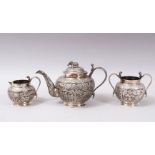 A GOOD 19TH CENTURY INDIAN SILVER THREE PIECE TEA SET, consisting of a teapot, 13cm high x 21cm